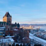 A winter vista of Québec City featuring the iconic Château Frontenac against a snowy skyline.