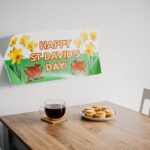 A cozy St. David's Day setup with tea, cupcakes, and festive decor.