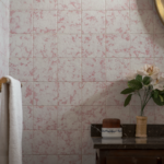 Charming bathroom scene with vintage tiles, a round mirror, and floral decoration.