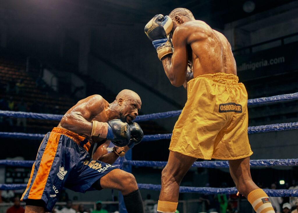 Two boxers face off in an intense match in Lagos, Nigeria. Skill and concentration on display.
