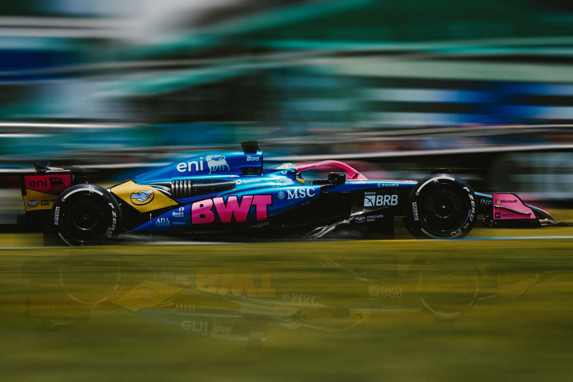 Dynamic shot of a Formula 1 car racing at Interlagos Circuit, São Paulo.