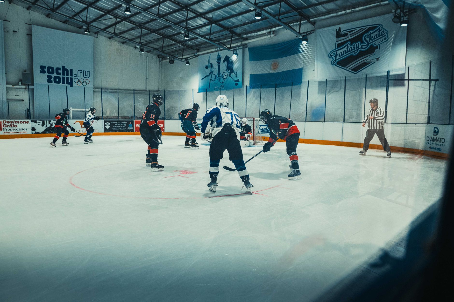 Competitive ice hockey game at Fantasy Skate Club in Buenos Aires, showcasing intense sports action on the rink.
