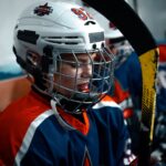 Close-up of a young ice hockey player in full gear, focused and ready for the game.