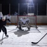 A dynamic moment captured during an ice hockey practice game in an indoor rink.