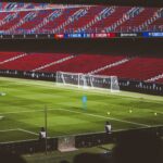 View of empty soccer field at FC Barcelona's Camp Nou with training equipment.