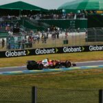 Exciting Formula 1 race action with Ferrari car at Interlagos, São Paulo, Brazil.