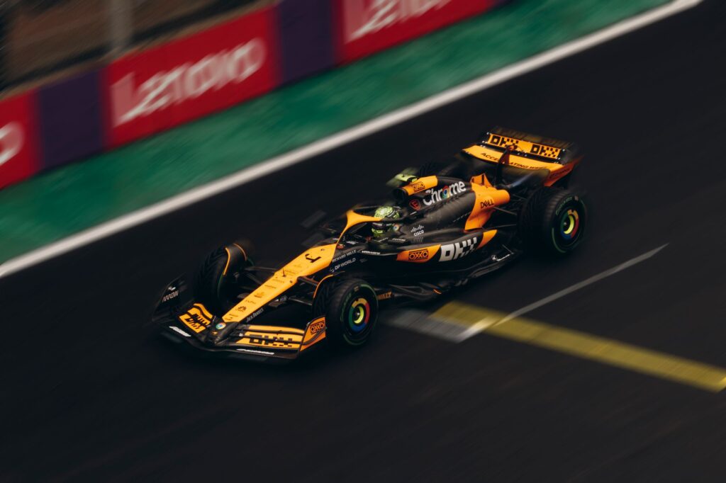 Dynamic shot of a Formula 1 car speeding on a race track during daytime.