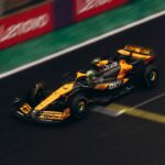 Dynamic shot of a Formula 1 car speeding on a race track during daytime.