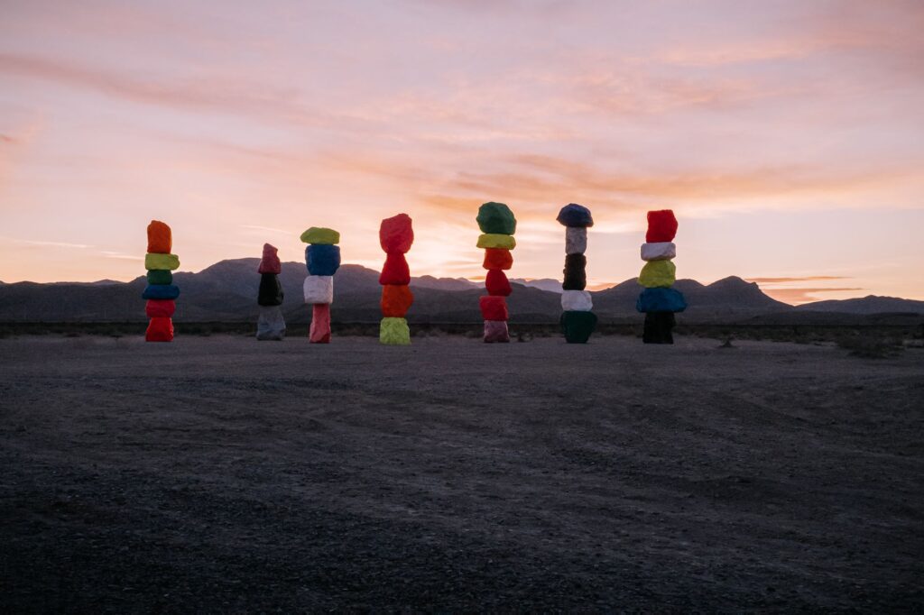 Colorful rock formations at Seven Magic Mountains near Las Vegas during sunset.