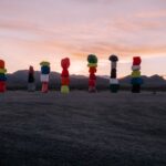 Colorful rock formations at Seven Magic Mountains near Las Vegas during sunset.