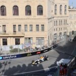 Exciting Formula 1 race scene at Baku City Circuit, showcasing high-speed action and historic architecture.