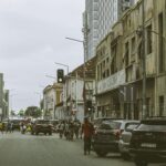 Bustling street scene in downtown Luanda, Angola with historic and modern buildings.