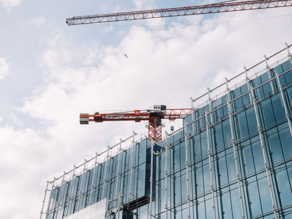 Architectural view of modern building under construction with crane, showcasing Dublin's urban development.