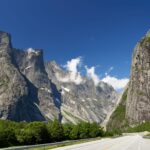 Breathtaking view of the mountains in Verma, Norway, with clear skies and a winding road.