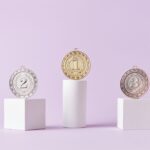 Medals on a podium against a soft pastel background, ideal for awards themes.