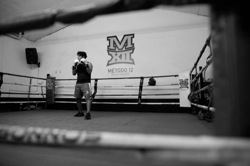 A boxer practicing alone in an indoor boxing gym in Buenos Aires, Argentina.