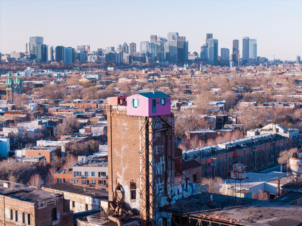 Captivating aerial view of Saint-Henri neighborhood with Montreal skyline in the background.