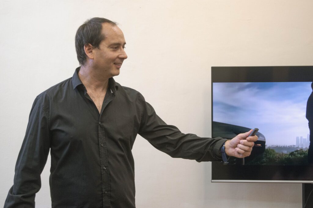Businessman presenting with remote in office setting, engaging presentation.