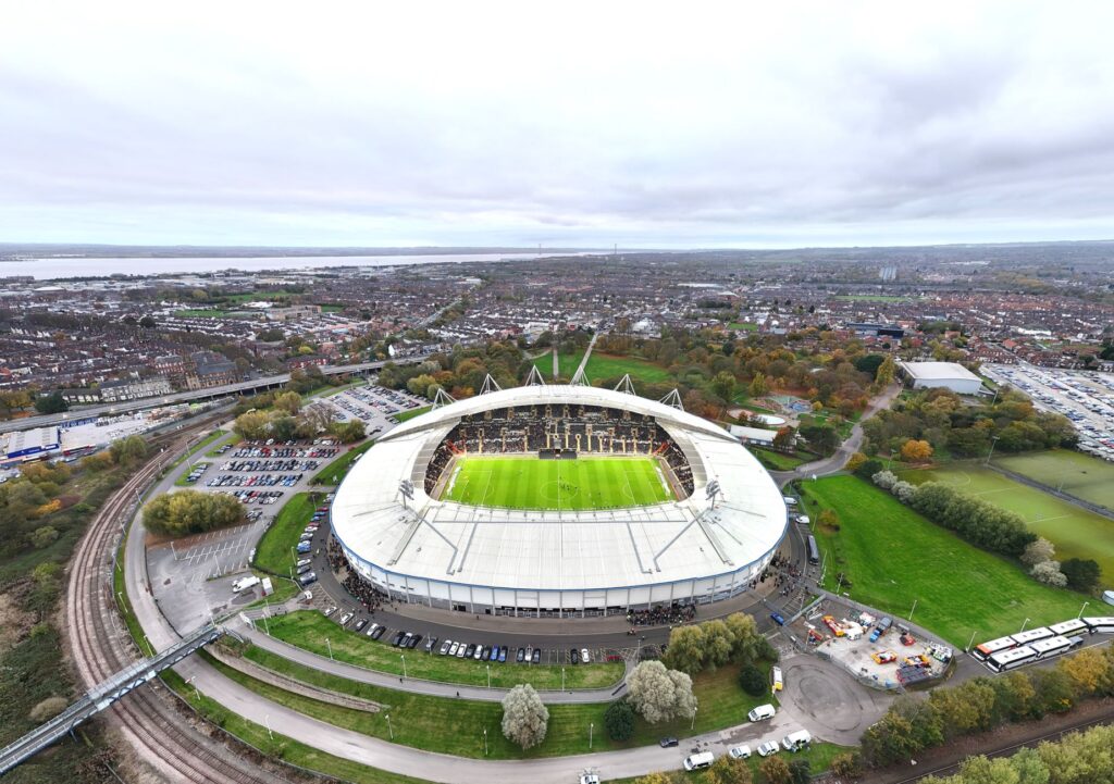 Aerial view of MKM Stadium in Hull, England, bustling with fans on match day.