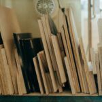 A collection of variously sized wooden planks neatly arranged in a workshop environment.