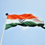The Indian national flag waves proudly against a clear blue sky in New Delhi.