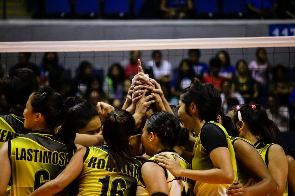 Female volleyball team huddles for a game in Quezon City, Philippines.