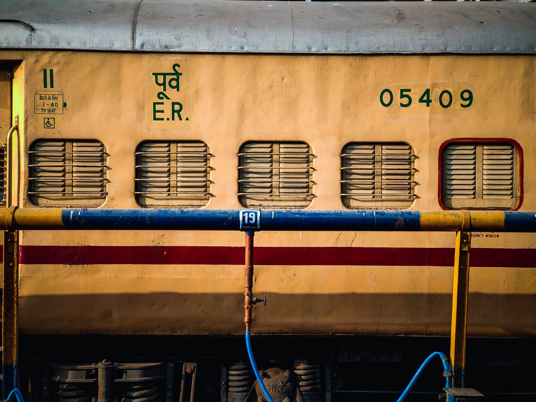 A close-up view of a yellow public train carriage with details and serial numbers visible. Ideal for transportation themes.
