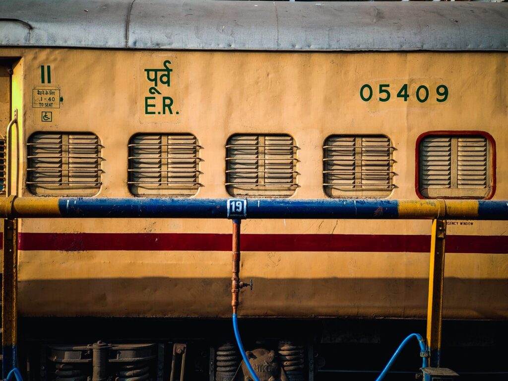 A close-up view of a yellow public train carriage with details and serial numbers visible. Ideal for transportation themes.