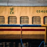 A close-up view of a yellow public train carriage with details and serial numbers visible. Ideal for transportation themes.