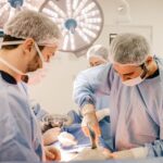 Team of surgeons working diligently in a well-lit operating room setting.