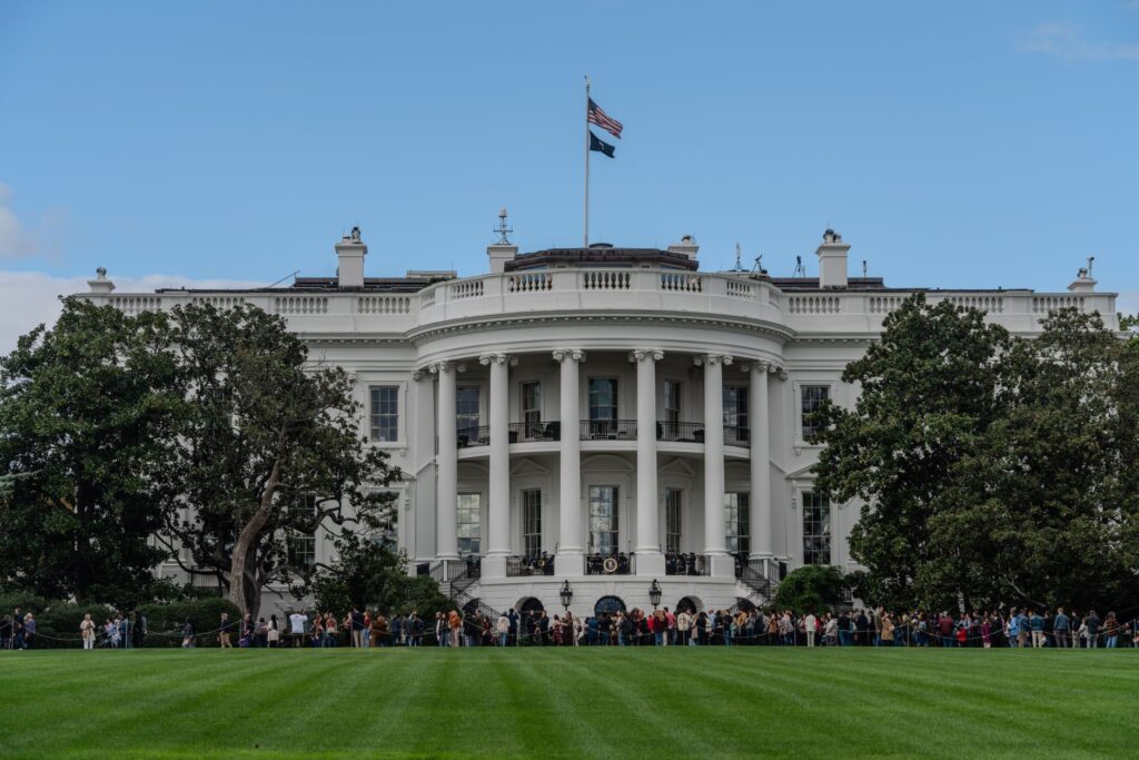 A picturesque view of the White House with the American flag in daylight.