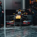 Red Bull Racing pit crew readying the Formula 1 car during an intense race event.