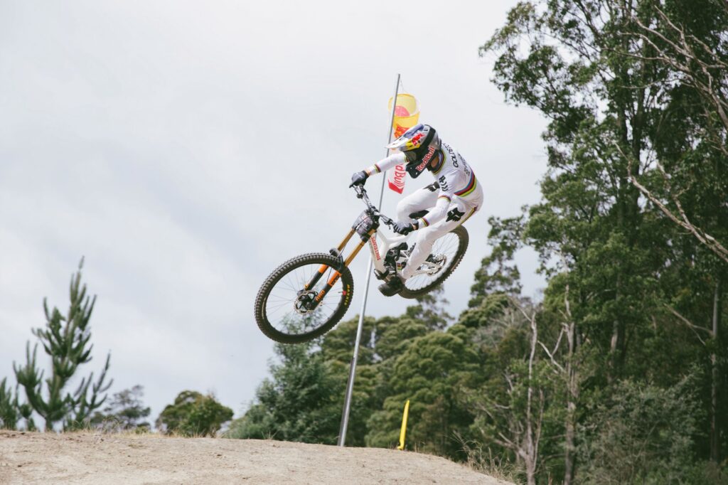 Professional mountain biker performing an aerial stunt in Maydena, Tasmania.