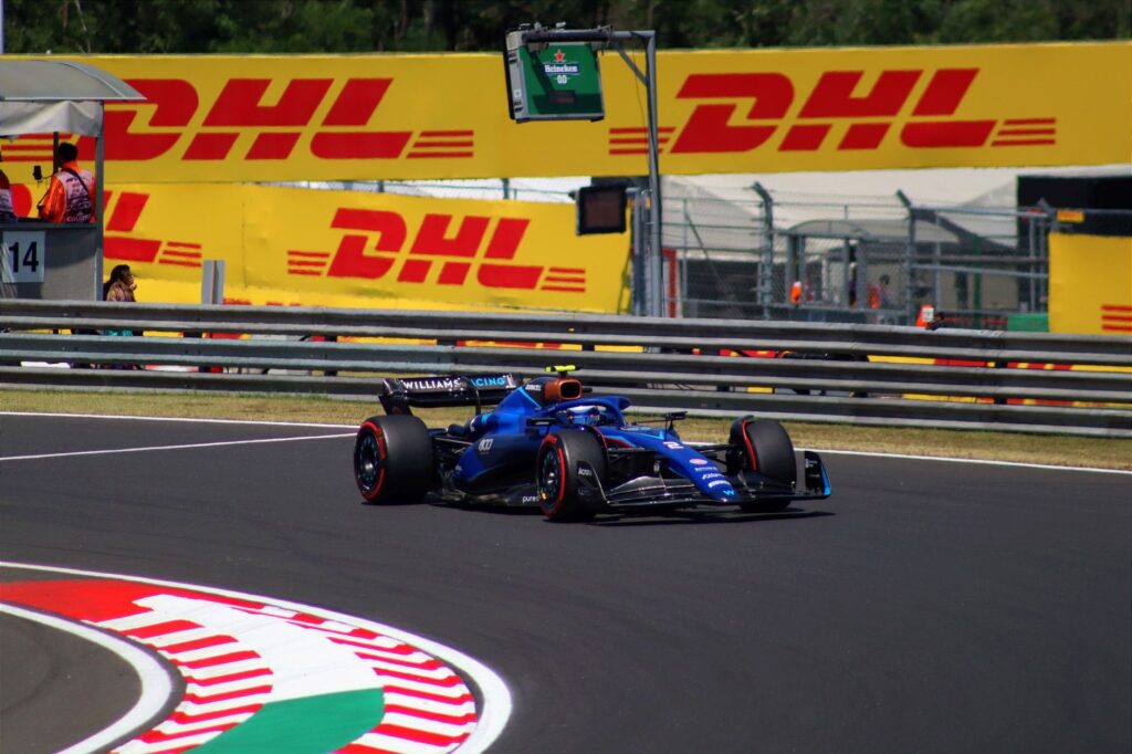 High-speed Formula 1 car on the track during a sunny day at Hungaroring, Hungary.