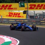 High-speed Formula 1 car on the track during a sunny day at Hungaroring, Hungary.