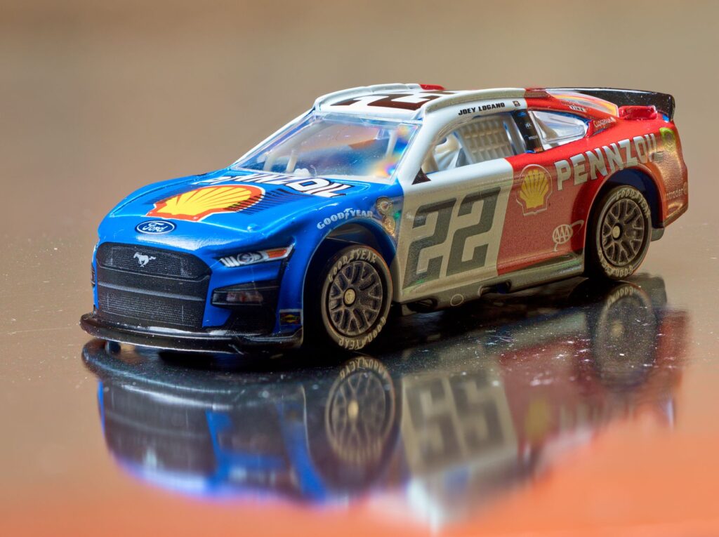 Close-up of a detailed scale model NASCAR car featuring a vibrant Shell-Pennzoil design.