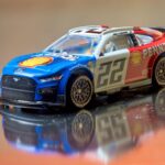 Close-up of a detailed scale model NASCAR car featuring a vibrant Shell-Pennzoil design.