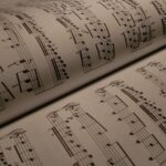 Detailed view of an open music book displaying musical notes and sheet music.
