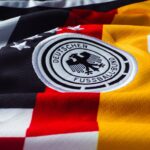 Detailed view of the German national football team jersey with emblem.