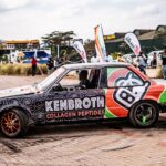 Colorful custom car wrapped with Kenbroth branding at an outdoor automotive event.