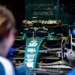 Aston Martin Formula 1 race car being prepared in the team garage before competition.