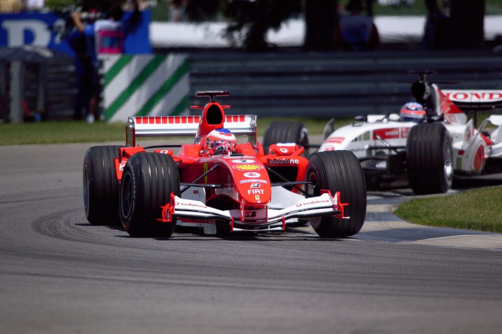 Thrilling Ferrari and Honda Formula 1 race at Indianapolis, showcasing motorsport excitement.