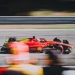 A thrilling shot of a Ferrari on the race track during the Italian Grand Prix.