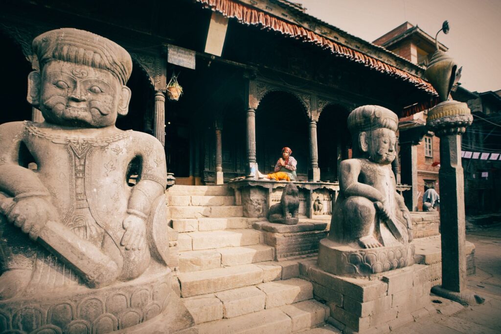 Stone sculptures at Bhaktapur's Dattatreya Temple, showcasing Nepalese art and culture.
