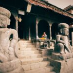 Stone sculptures at Bhaktapur's Dattatreya Temple, showcasing Nepalese art and culture.