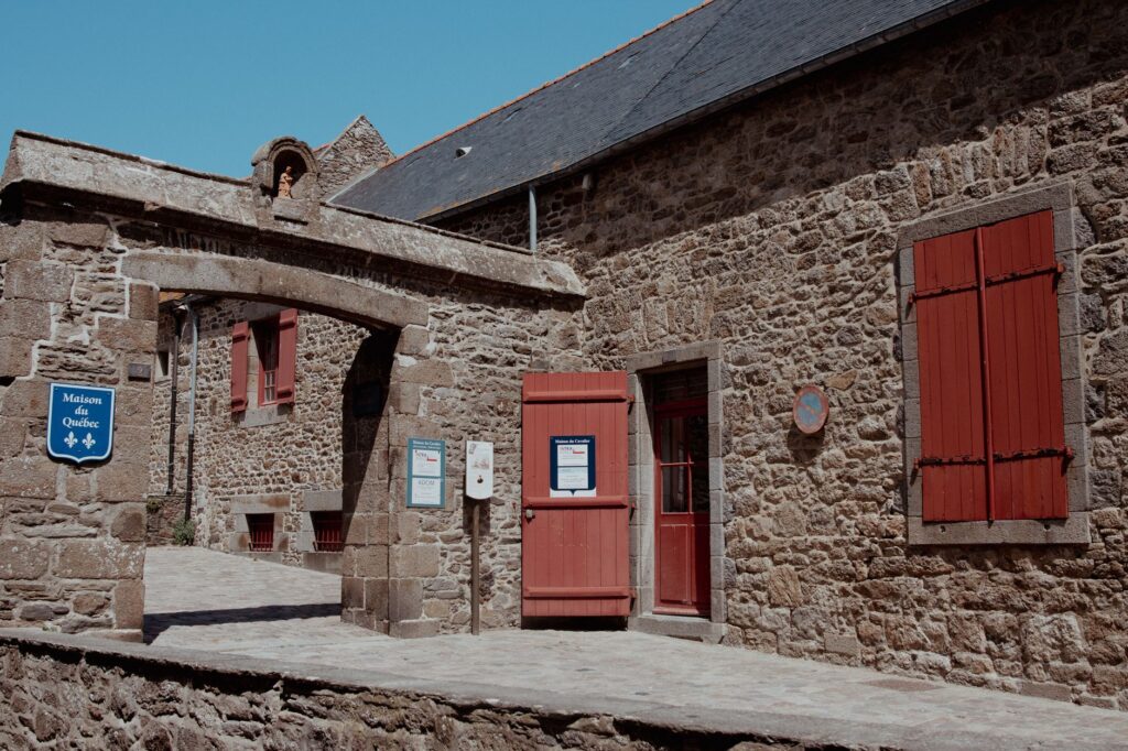 Charming historic stone buildings and archway in Saint-Malo, France.
