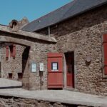 Charming historic stone buildings and archway in Saint-Malo, France.