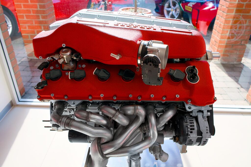 Powerful red engine on display indoors, showcasing intricate mechanics and engineering brilliance.