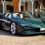 Elegant green Ferrari sports car with alloy wheels displayed outdoors, showcasing speed and Italian design.