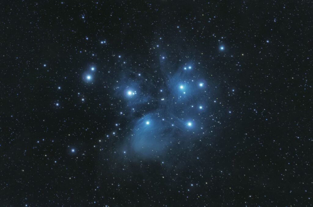 Captivating image of the Pleiades star cluster against a starry night sky.